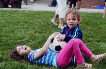 Lily Conway and her brother Odin had a blast playing soccer together on the sod that was laid down on Main Street. (Proceeds from the sale of the sod are going to Habitat for Humanity).