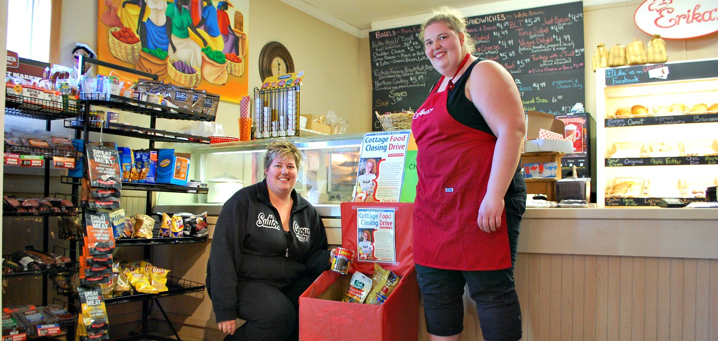 Tanya (left)and Erika Grainger with the cottage closing food drive donation bin at Erika’s