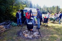Corn on the cob is cooked over an open fire.