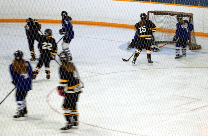 #6 Morgan McCartney (background, far left) knocks in the third and game-winning goal against the North Simcoe Capitals