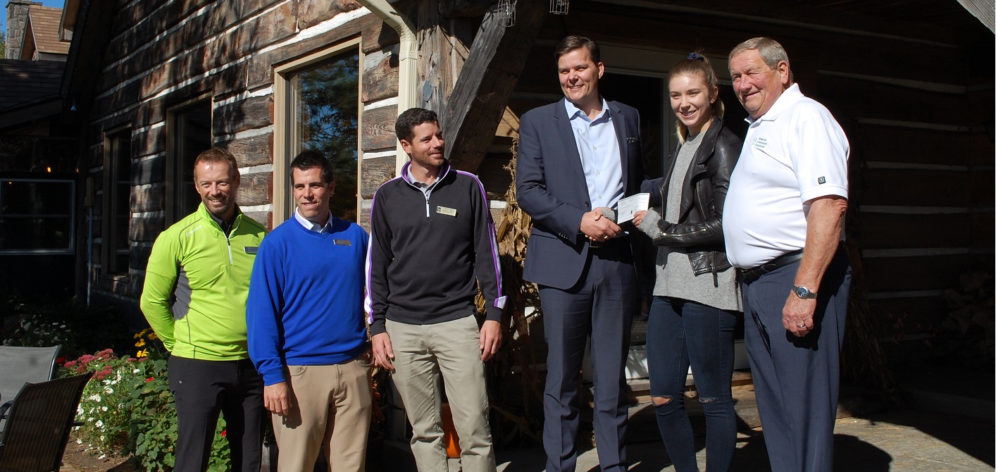 (From left) Roger Penney, Ryan Barry, Andrew Nieder, and Luke Nixon-Janssen of Deerhurst Resort present a cheque to skier Dara Howell and Gord Durnan of the Muskoka Community Foundation