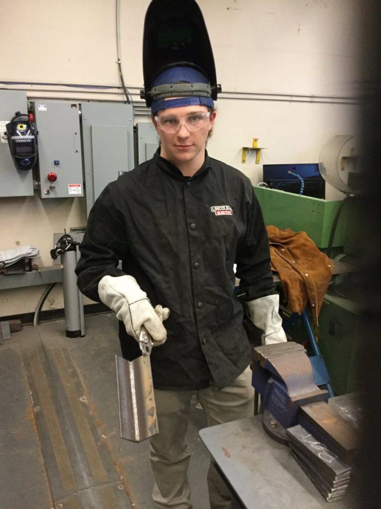 HHS Manufacturing student Blake Schmitz shows off one of the first welds made with the new equipment (Photo: Jim Milne)