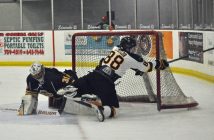 Otters goalie Mitchell Jones #31 tangles with an Alliston player