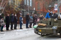 A World War II Universal Carrier Mark II passes the honour guard in front of Town Hall