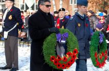 Mayor Scott Aitchison and an air cadet lay wreaths for the Town of Huntsville and the Legion Seniors Manor