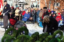 A veteran from Fairvern Nursing Home salutes Sergeant-at-Arms Tony Evans.