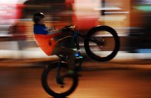An Algonquin Outfitters riders pops a wheelie on his fat bike