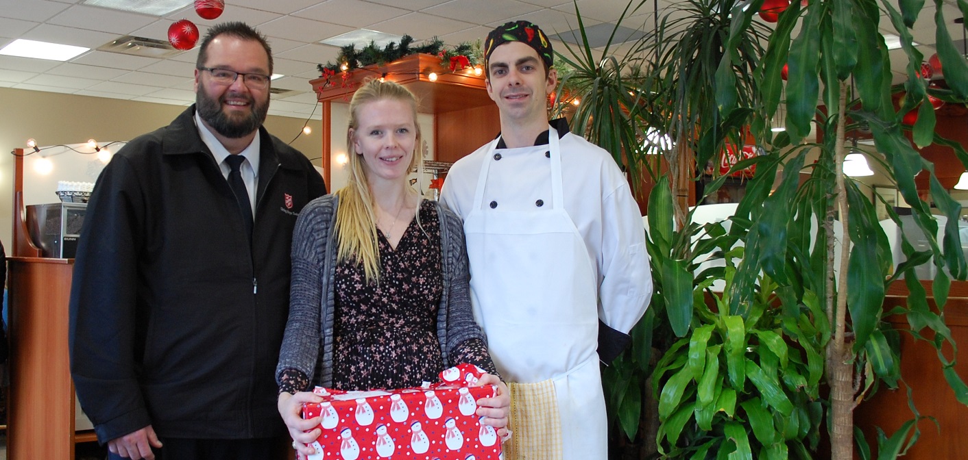 (From left) Salvation Army Major Darren Wiseman with Jenny Spring and Oliver Wolfe, new owners of Family Place Restaurant and Pizza
