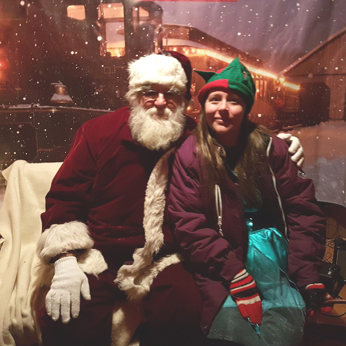 Jolly old St. Nick and his merry elf take a break from Christmas Eve preparations for Huntsville's version of the Polar Express