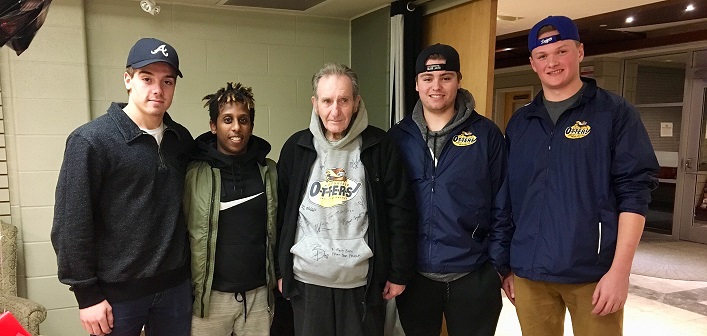 Otters (from left) Cody Jones, Ermi Mulatu, Mitchell Jones, and Quinn Thompson help volunteer Rex Malloy (centre) celebrate his 80th birthday (Photo: Andrea Johnston)