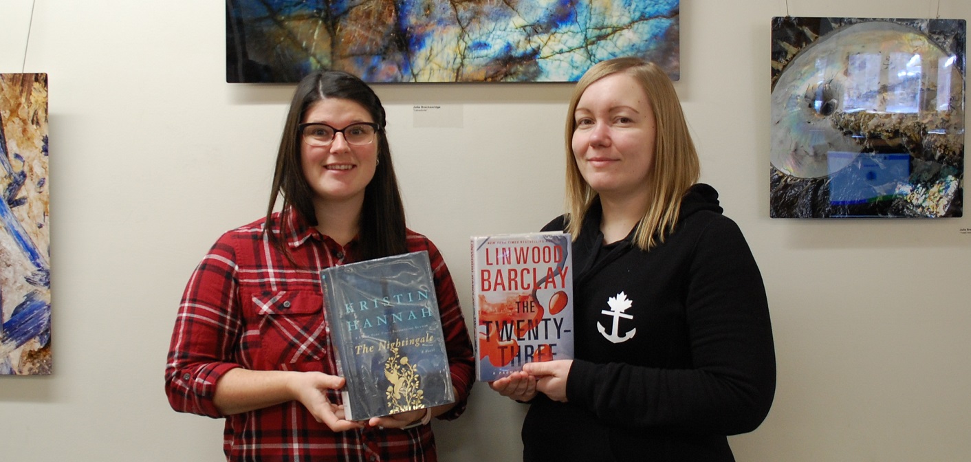 Cortney LeGros (left) and Julie Manczak with two of HPL’s top 10 books of 2017