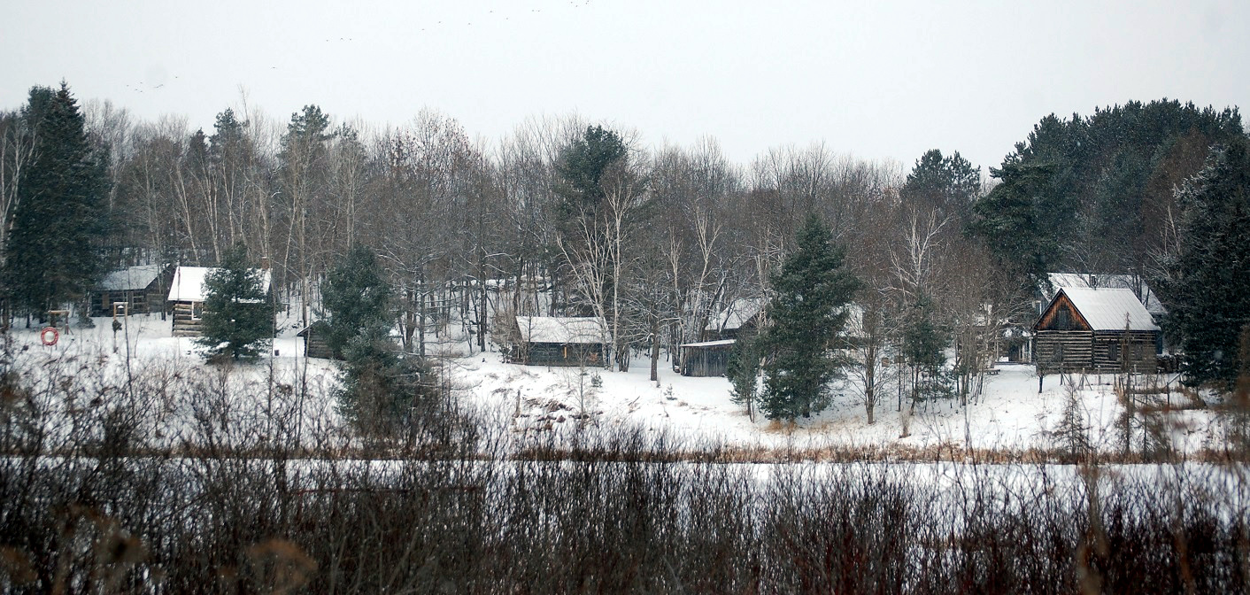 Muskoka Heritage Place’s pioneer village as viewed from across Cann Lake