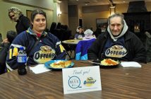 Long-time Otters volunteer Rex Malloy (right) and a fellow fan, Candace, display their Otter pride at the Code Blue spaghetti dinner