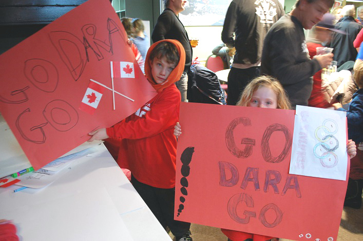 Greg-Charlie (left) and Joni Munce made these posters to help cheer on Dara