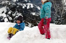 Finn (left) and Sophie Roberts find some simple winter fun in a snowbank