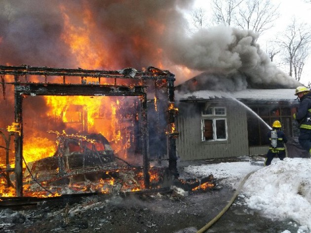 Vehicle fire that began inside garage destroys home