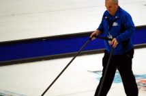 Ontario Tankard volunteer Craig Abernethy sweeps the ice before a draw (Photo: Dawn Huddlestone)