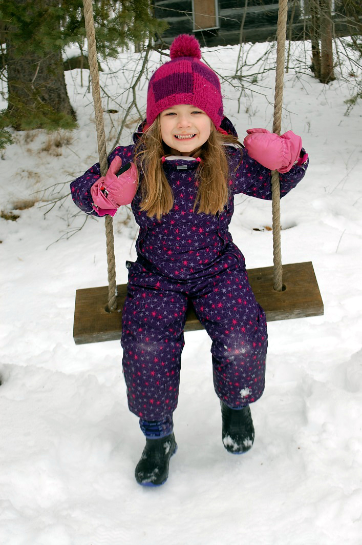 The old wooden swing outside the Pioneer Village's schoolhouse had Nevaeh Krajnc giggling