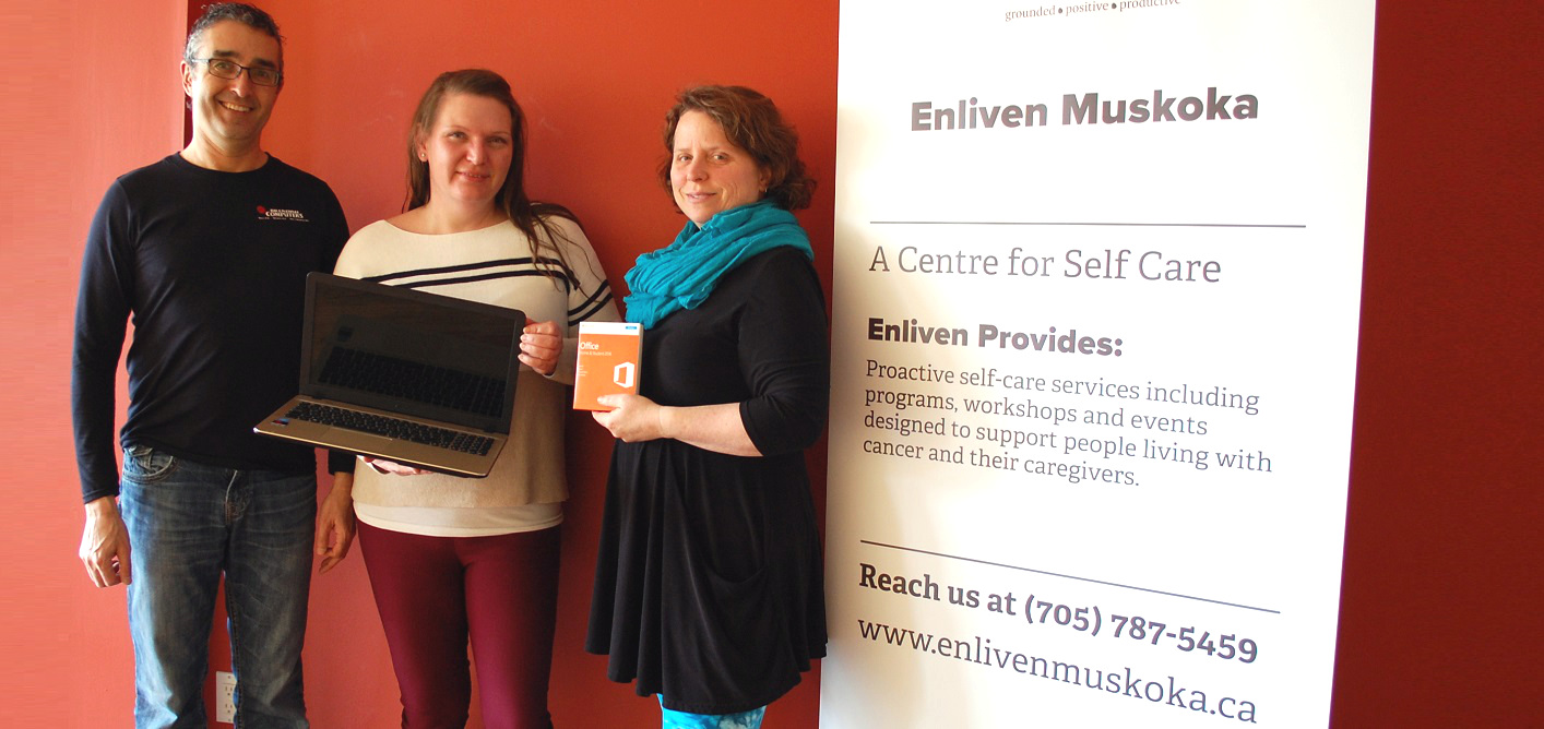 (From left) Jim Brendish of Brendish Computers presents a new laptop to Catherine Prosser and Allie Chisholm-Smith of Enliven