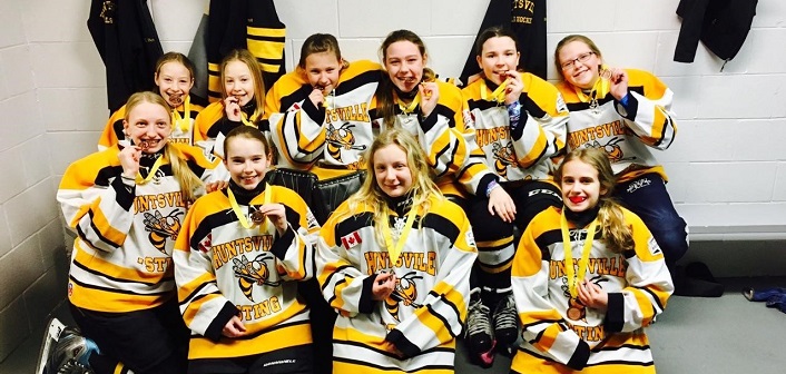 The Huntsville PeeWee Sting Yellow show off their bronze medals at the 37th annual Walter Gretzky Girls Hockey Tournament