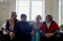 Hospice volunteers (from left) Judy White, Martha Watson, RN Braedi Waymouth and Angel Benn share a laugh on a comfy couch at Algonquin Grace Hospice. That's the thing about hospice. It's made to feel like a home away from home. Staff regularly thank the volunteers and that has a big impact on their willingness to want to help.
