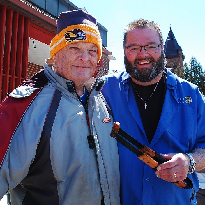 Audlee Tredgett (left) stopped in to check on the sausages being cooked by Major Darren Wiseman of the Salvation Army.