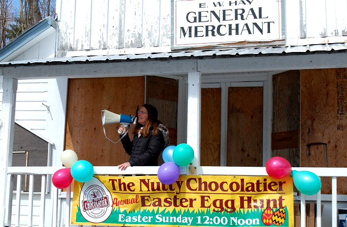 Nutty Chocolatier owner Nancy Wenger welcomes the crowd to the 21st annual Easter Egg Hunt
