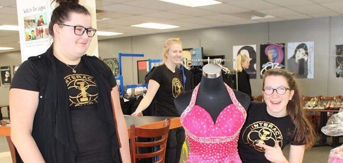 (From left) Ella Cushman, Brianna Todd (in back), and Madeline Gosset with one of the donated prom dresses