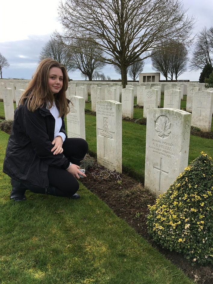 Hayden Phillips with the headstone of her relative G.B Nelles (supplied photo)