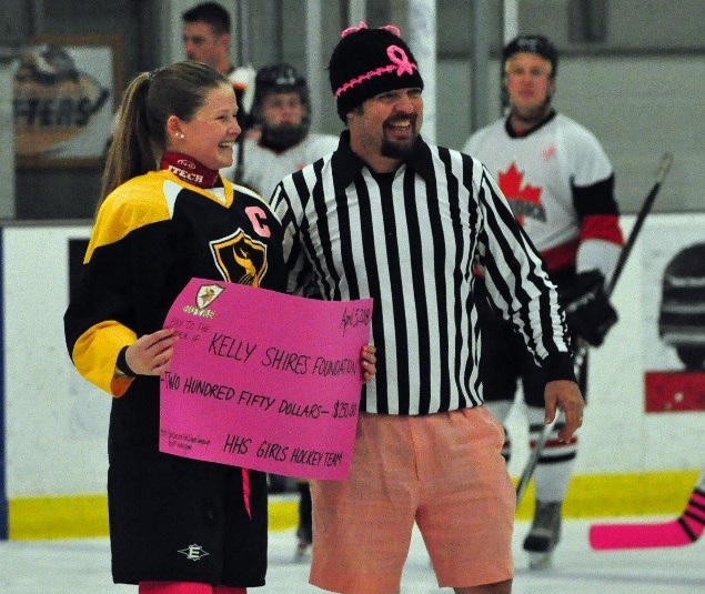 Scott Doughty (right) accepts a cheque from Hoyas team captain Lindsay Young on behalf of the Kelly Shires Foundation