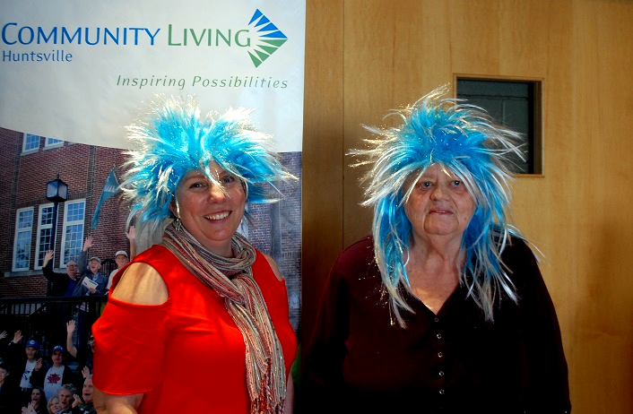 Suzanne Willett (left) and Linda McEachern wear wigs to show their commitment to dye their hair blue and green if enough money is raised for Community Living Huntsville at Band on the Run