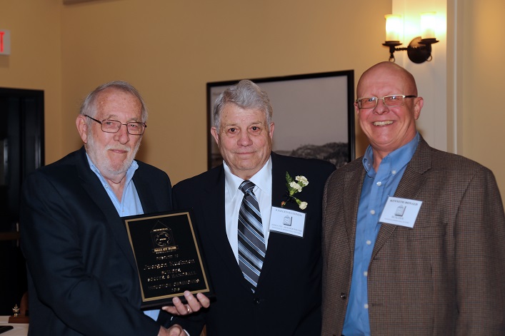 Hall of Famers Peter Jacob (left) and Kenneth Donald (right) present an award to Juergen Kuehnen