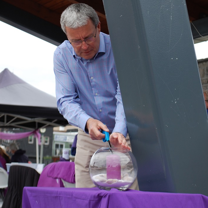 Hospice Huntvsille Board President Gord Schakelaar lights a memorial candle