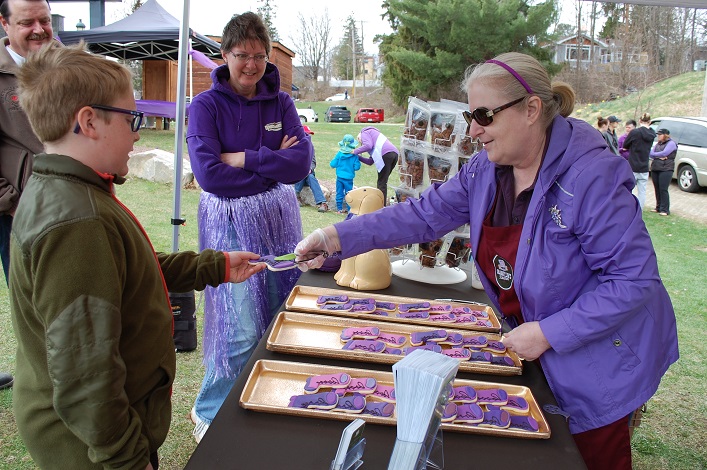 Lynda McLeod of Granny's Kitchen serves up a purple boot cookie to Ethan Spence