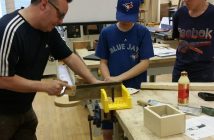 The construction team practices their skills at the HHS wood shop with teacher Jeff Brady (left)