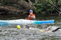 Kayaks and boats were in the water for swimmers safety if needed