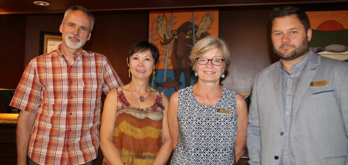 (From left) John Ovcacik, winner of the Algonquin 125th Birthday Art Contest, is congratulated by Eclipse Gallery manager Karin Kriekaard, Deerhurst Resort Director of Marketing Laura Kennedy and General Manager Jesse Hamilton.