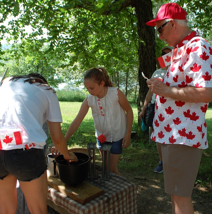 Liz Saburov (centre) tries her hand at candlemaking