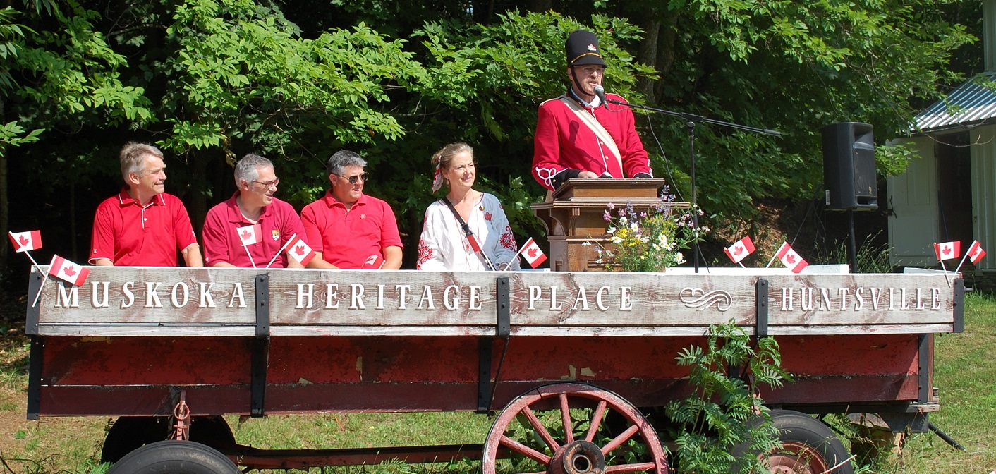 Captain George Hunt (right) welcomes the crowd to Muskoka Heritage Place with (from left) MPP Norm Miller, MP Tony Clement, Mayor Scott Aitchison, and the Town’s Manager of Arts, Culture and Heritage, Teri Souter