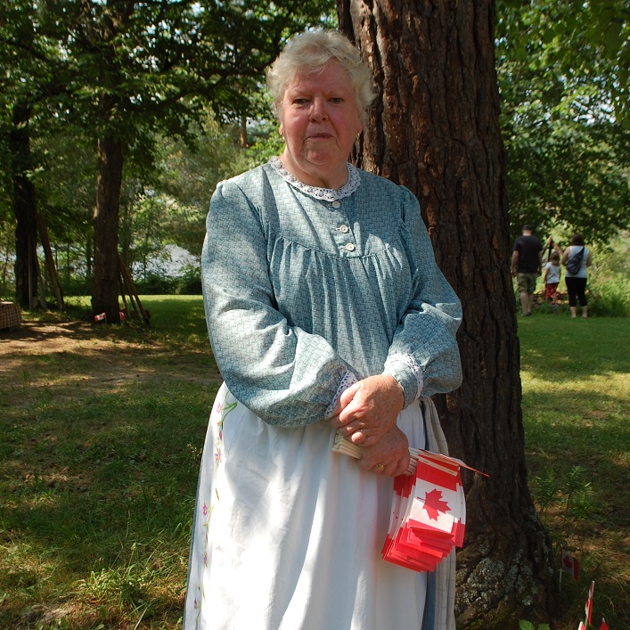 Janice Berkenmeier hands out flags to help people celebrate