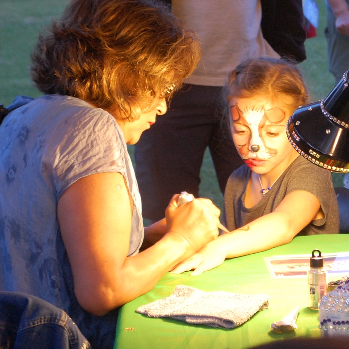 Sophie Mann is mesmerized by the henna being applied to her arm