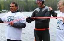 Glenn cuts the ribbon on his first leg of the swim on May 19 (Photo: Anne Collins via @glenn.vickery/Instagram)