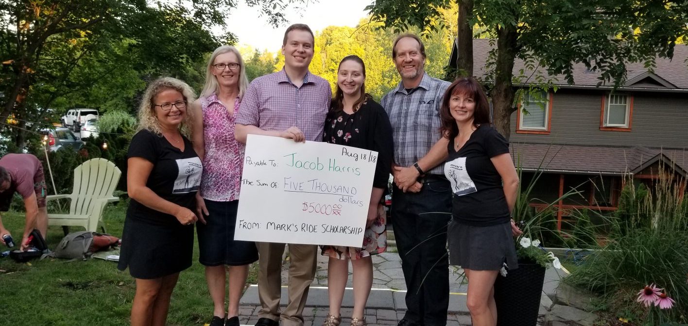 Carrie Campbell (left) and Tracey Christian (right) present law student Jacob Harris (third from left) with a $5,000 Mark’s Ride scholarship (submitted photo)