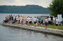 Some of Glenn's supporters await his arrival at the South Portage dock