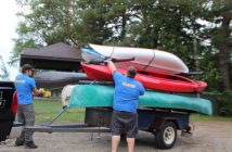 Volunteers transport the boats from Hidden Valley to the start of the paddle route at Hutcheson Beach.