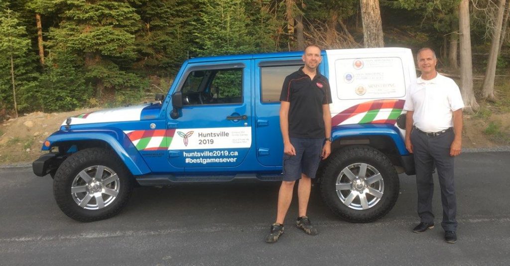 Steve Cowan (left) and Brad Cartwright, GM of Armstrong Dodge, with the Huntsville 2019 Ontario 55+ Winter Games Jeep (supplied photo)