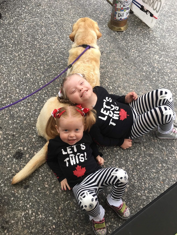 Marika (left) and Stasyia Richardson chill with their friend's dog Cyprus (Photo: Cori-Anne Bliss Richardson)