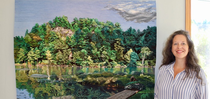 Marni Martin with one of her most recently woven tapestries (supplied photo)