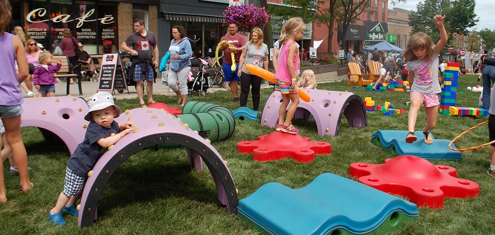 Kids flocked to the toys in the temporary grassy park on Huntsville's Main Street for the Summer Sidewalk Sale