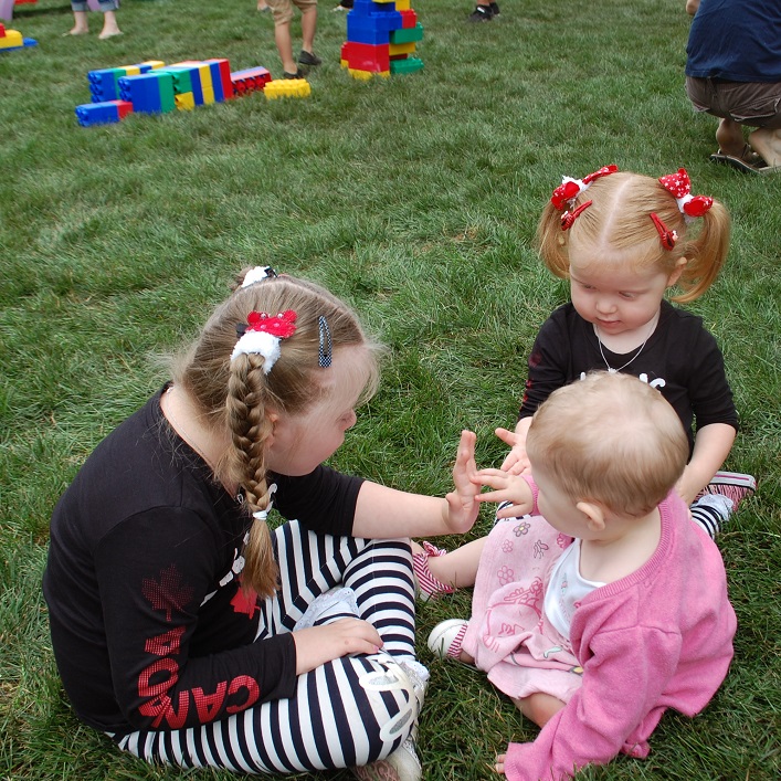 Stasyia (left) and Marika (right) Richardson share high fives with Henley Stroud